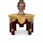 uddha Head Statue on Decorative Pedestal Table.